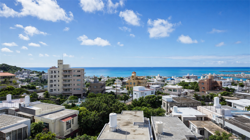 那覇市の住宅街とマンション、遠くに海が見える風景